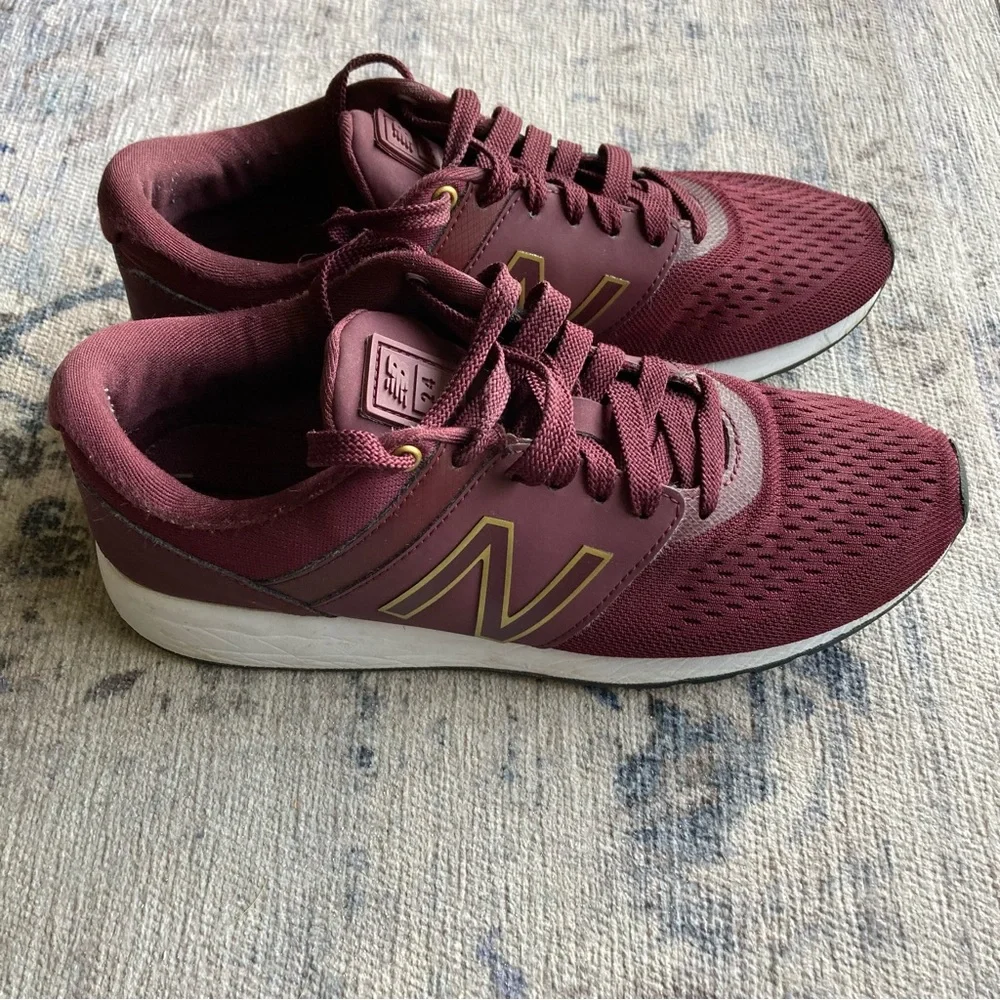 New Balance women’s Burgundy Sneakers with Gold Accent